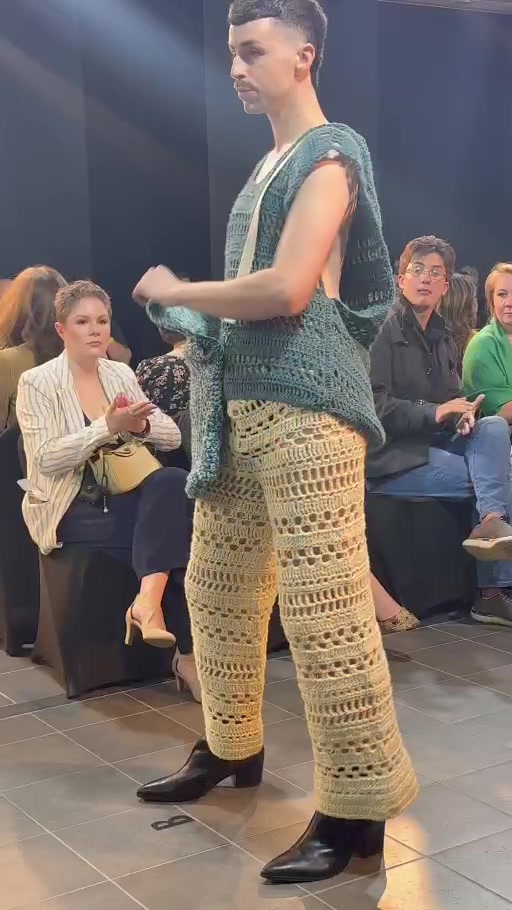 Home Runway model walking in cream mixed-lace crochet pants with a teal open-work crochet top and black heeled boots